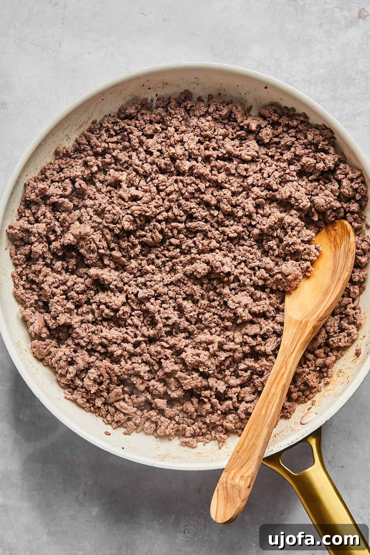 Ultimate Slow Cooker Taco Chili Recipe 4 Ground beef browning in a large skillet over medium-high heat, showing the initial cooking stage for the chili.