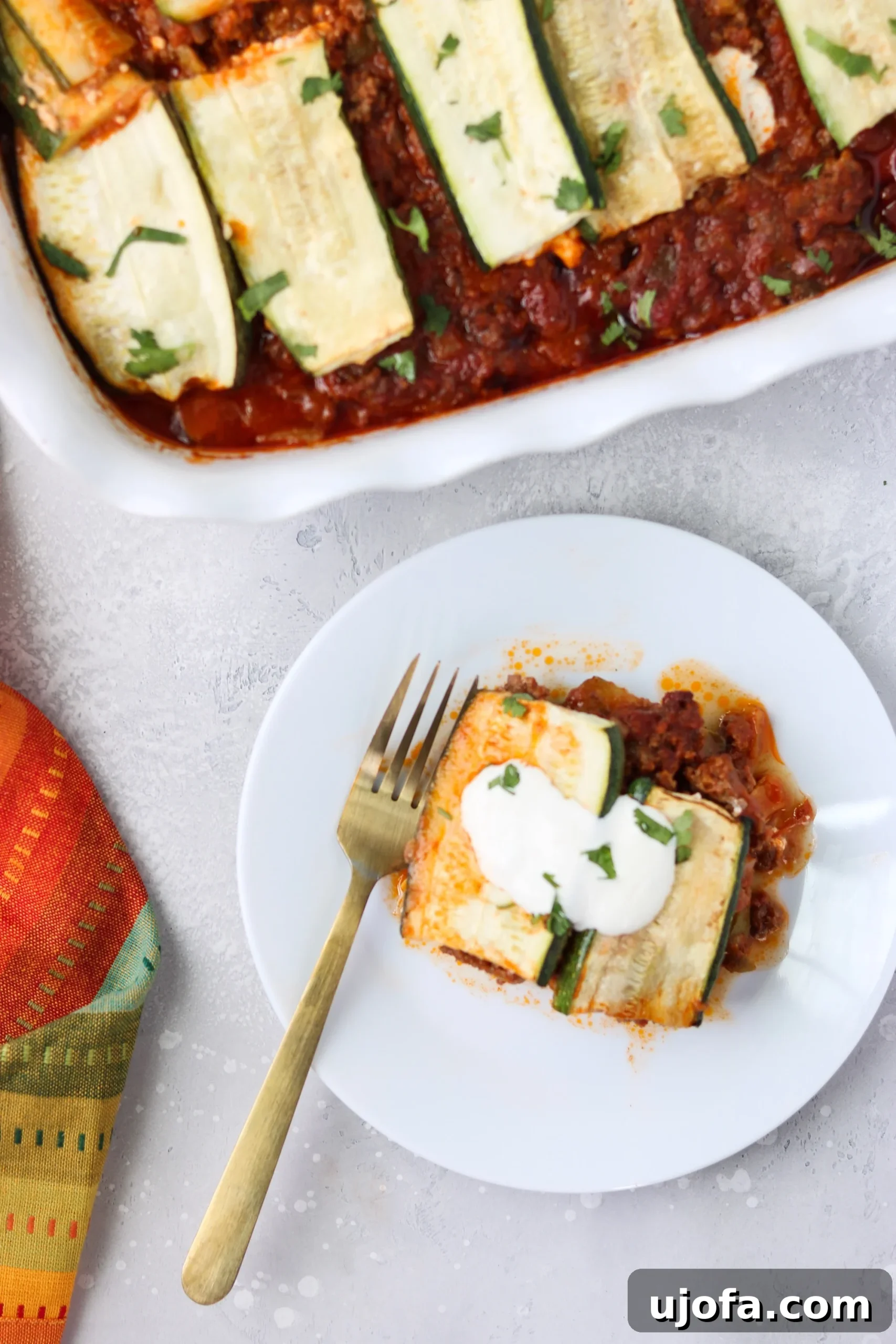 Detailed shot of the Paleo Mexican Lasagna baking in a dish, with golden-brown edges and bubbling sauce.