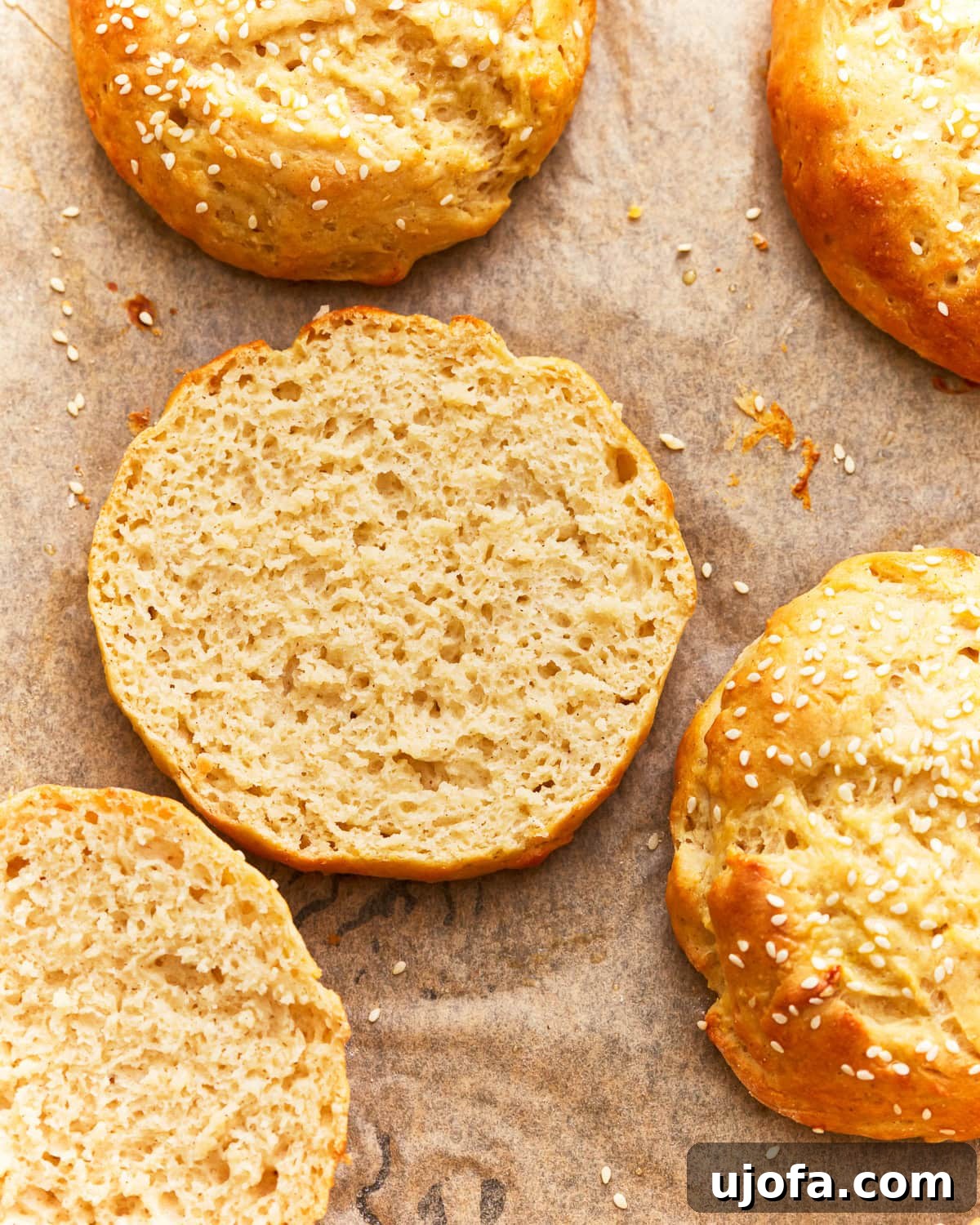 Burger Bliss Without The Gluten 12 Close-up overhead view of a perfectly sliced gluten-free hamburger bun, revealing its soft and airy interior.