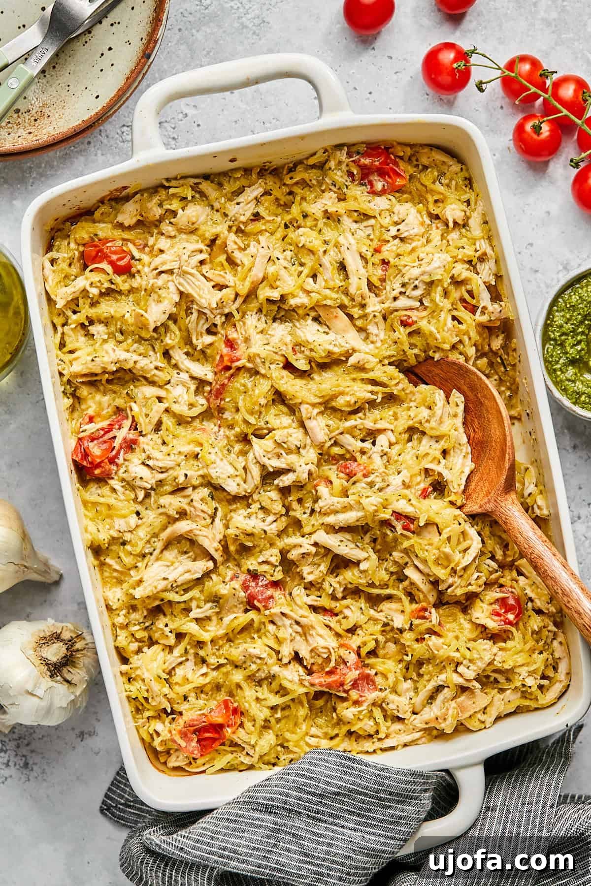 Dreamy Boursin Chicken Bake 12 a spoon scooping boursin chicken and spaghetti squash out of a casserole dish