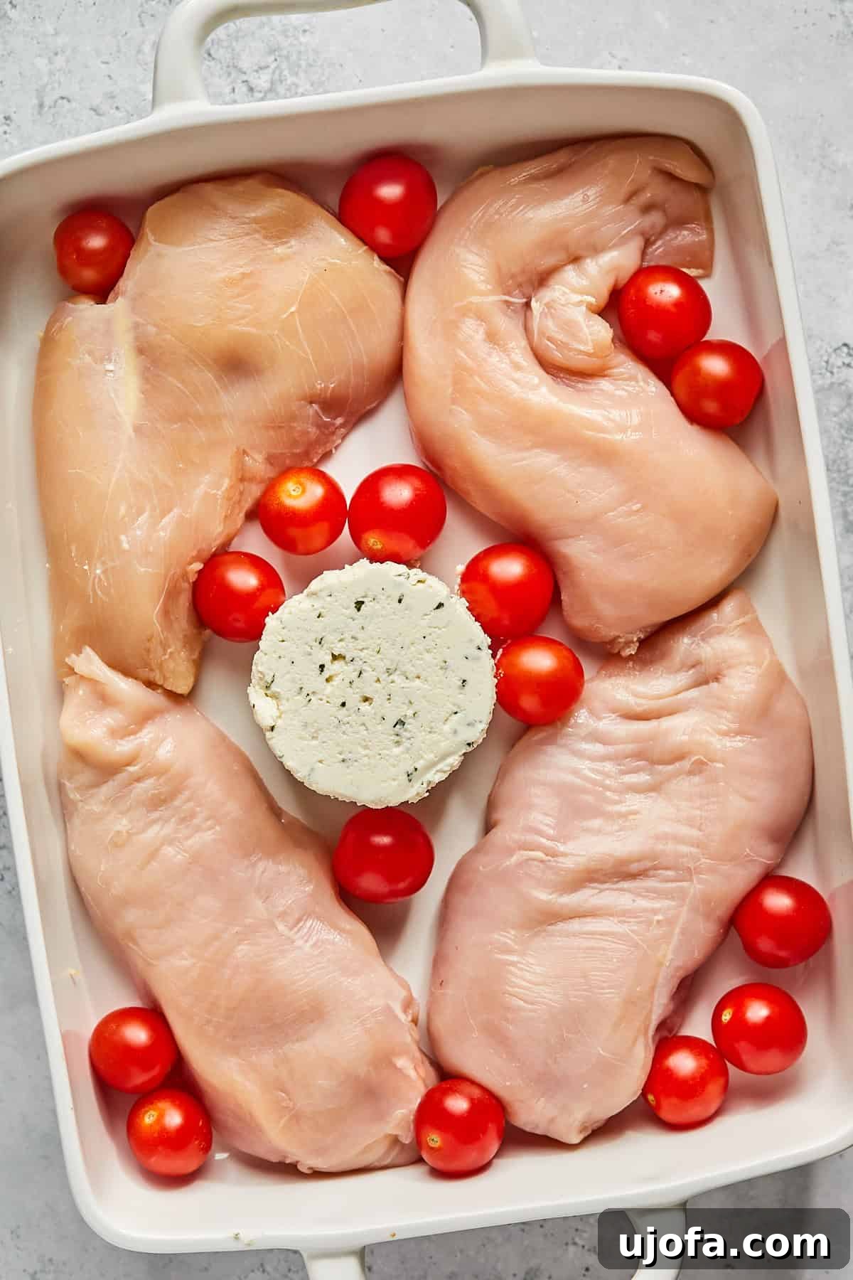 Dreamy Boursin Chicken Bake 4 chicken breasts, tomatoes, and cheese in a casserole dish