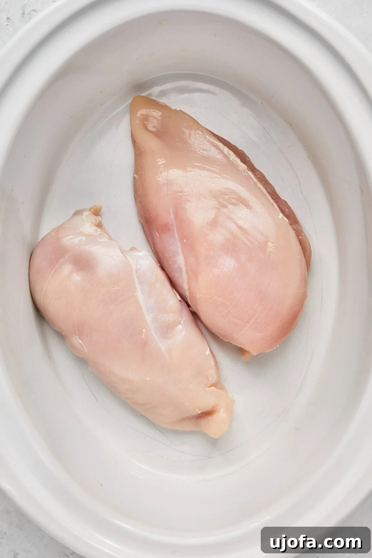 raw chicken in a slow cooker