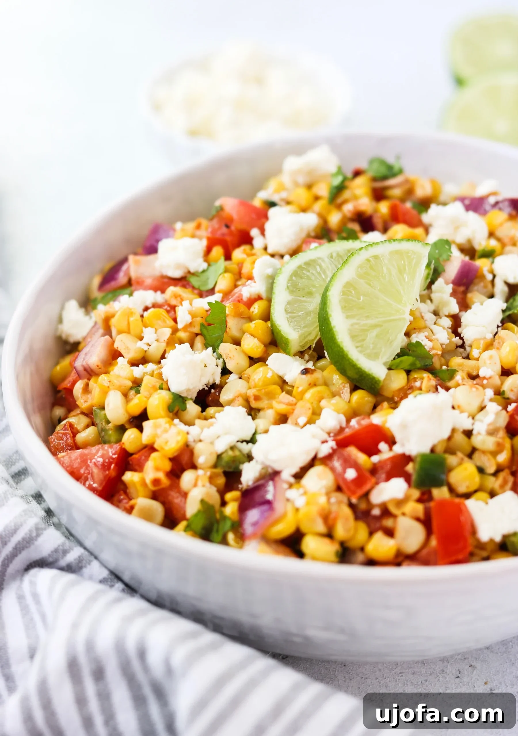Close-up of the deconstructed Mexican Street Corn and Tomato Salad, showcasing its fresh ingredients.