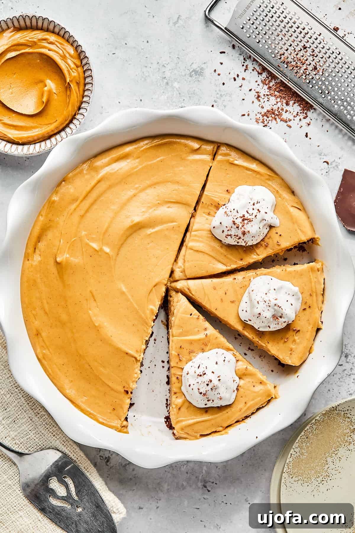 No-Bake Vegan Peanut Butter Bliss 14 A beautiful slice of dairy-free peanut butter pie, topped with a generous swirl of whipped cream and a sprinkle of chocolate shavings, ready to be enjoyed.