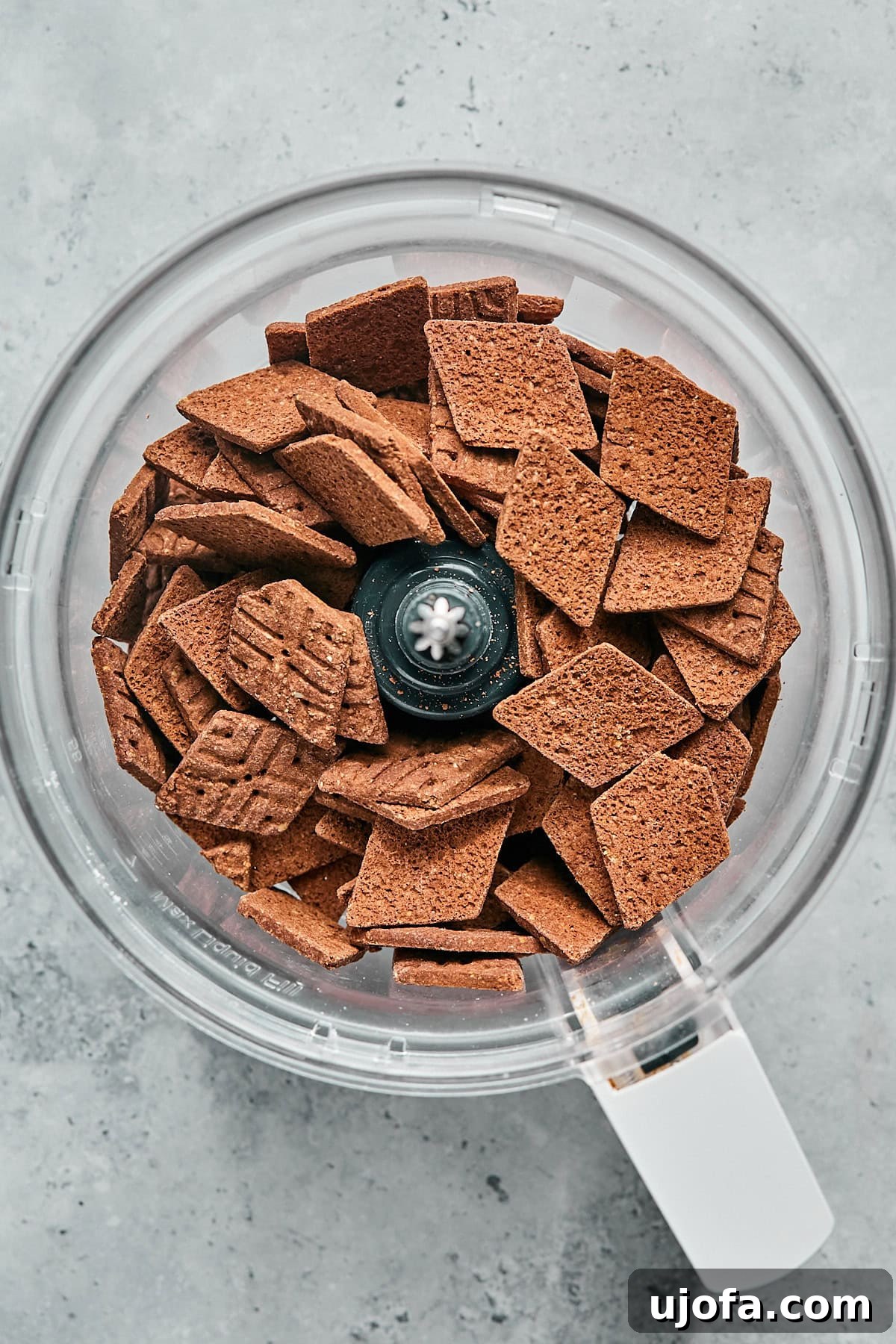 No-Bake Vegan Peanut Butter Bliss 4 Gluten-free chocolate thin cookies being added to a food processor.