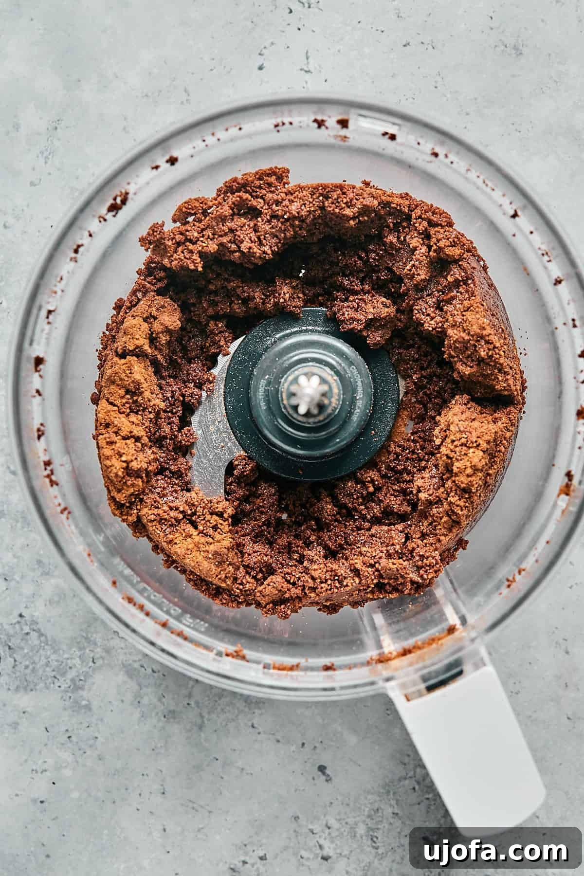 No-Bake Vegan Peanut Butter Bliss 6 Melted vegan butter being mixed with ground chocolate cookies in a food processor.
