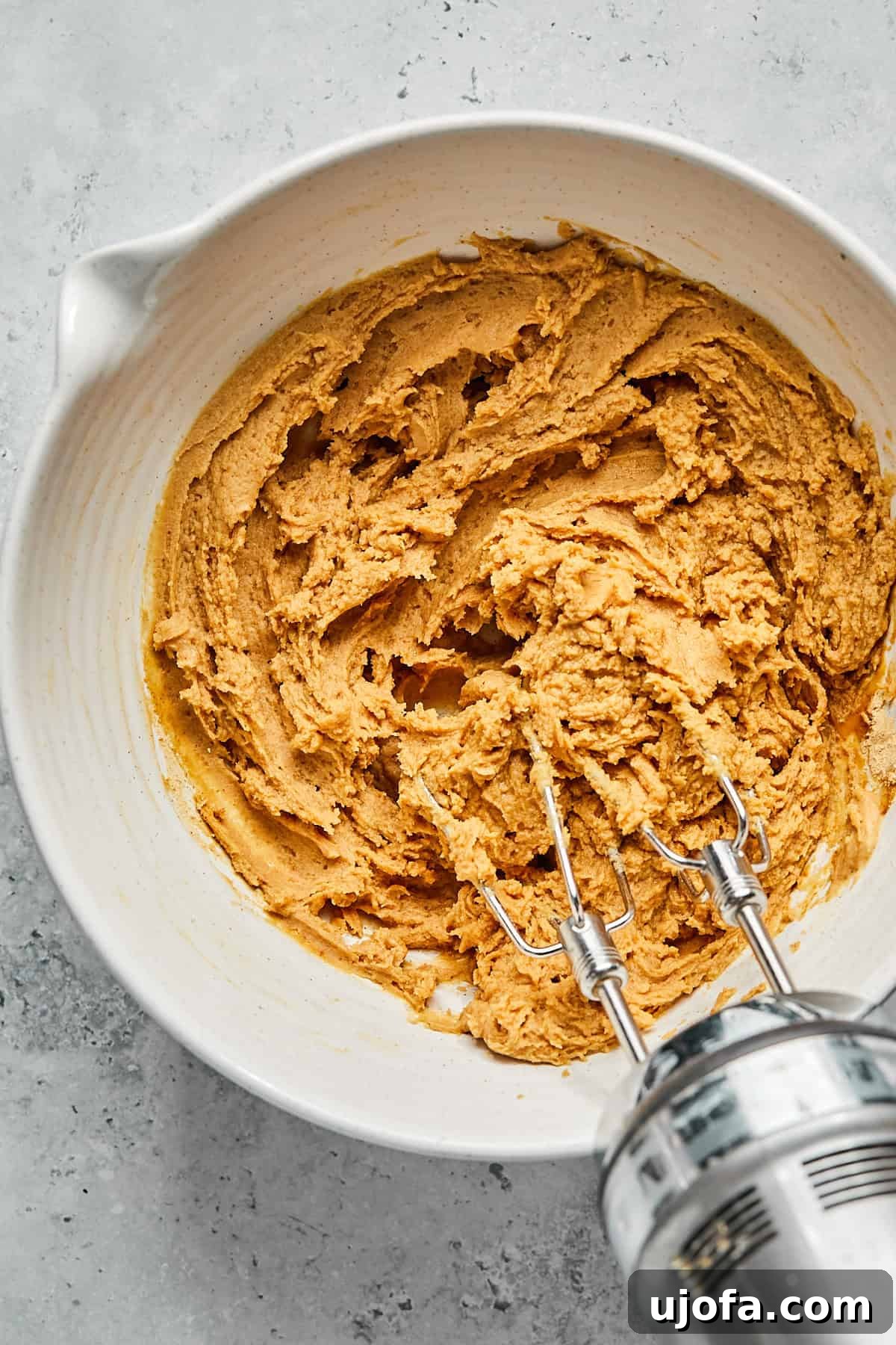 No-Bake Vegan Peanut Butter Bliss 9 Peanut butter pie filling ingredients thoroughly mixed together in a bowl, creating a smooth, light brown mixture.
