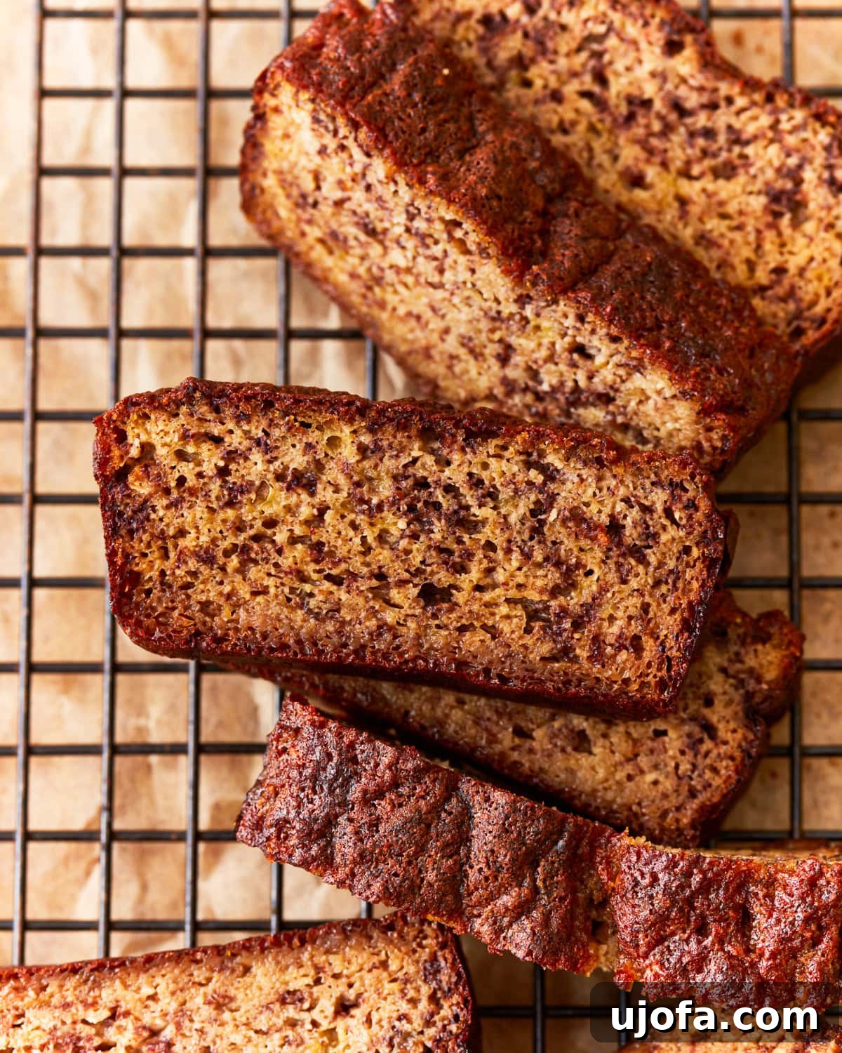 Tropical Coconut Banana Bread 4 overhead view of perfectly sliced coconut flour banana bread on a wire rack, ready to be enjoyed.