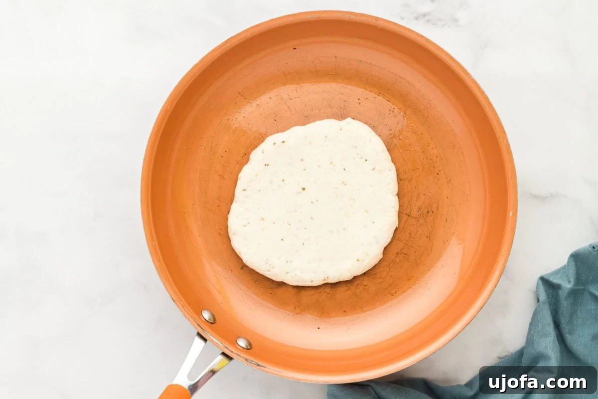 Effortless Gluten-Free Flatbread 11 gluten-free flatbread dough in an orange skillet, ready to cook