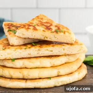 Effortless Gluten-Free Flatbread 6 cut gluten-free flatbread stacked on a wooden cutting board, ready to serve