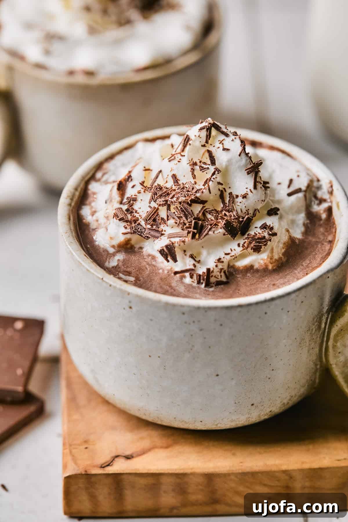 Cozy Protein-Packed Cocoa 2 Rich protein hot chocolate in a festive mug, topped with fluffy whipped cream and delicate chocolate shavings, perfect for a cozy treat