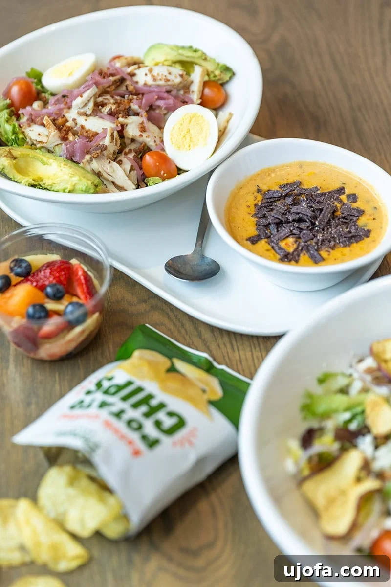 Navigating Panera Gluten-Free Options 3 A selection of Panera's gluten-free options, including a salad and chips, on a rustic wooden table.