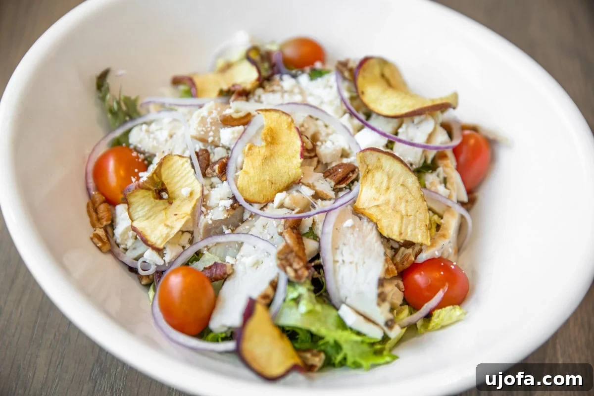 Navigating Panera Gluten-Free Options 4 A close-up of Panera's Fuji Apple Chicken Salad with grilled chicken, apples, and pecans.
