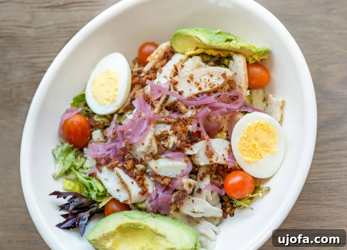 Navigating Panera Gluten-Free Options 7 A vibrant Green Goddess Chicken Cobb Salad from Panera, with chicken, eggs, and avocado.