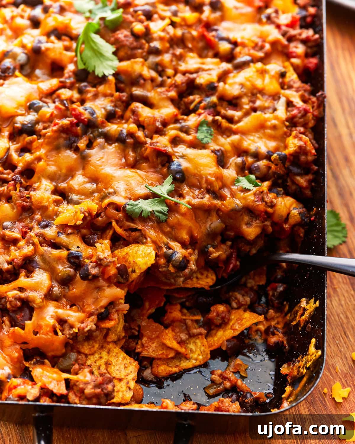 Unbagged Taco Bake 2 A scoop removed from a baked walking taco casserole, showing the cheesy layers.