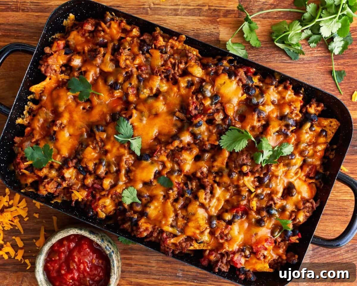 Unbagged Taco Bake 10 Baked walking taco casserole topped with fresh cilantro, with a side of salsa.