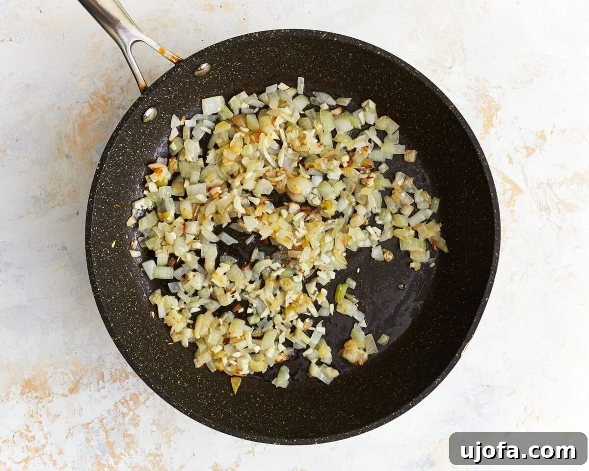 Unbagged Taco Bake 5 Diced onions cooking in a large skillet until softened.