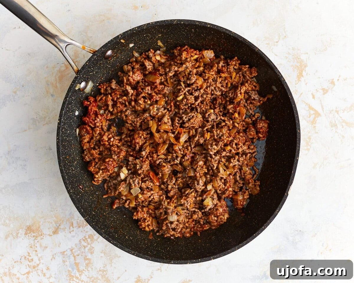 Unbagged Taco Bake 6 Cooked ground beef in a skillet, seasoned and ready for the next step.