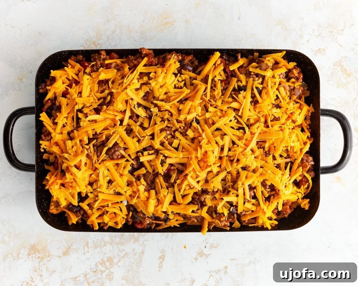 Unbagged Taco Bake 9 Unbaked walking taco casserole showing the layers of chips, beef, and cheese.