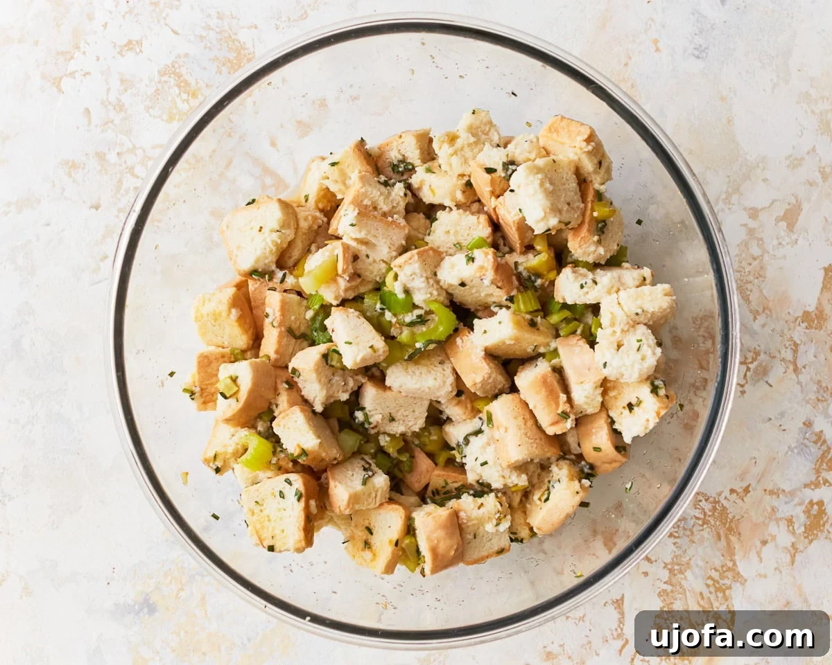 Flavorful Gluten-Free Stuffing 12 Gluten-free stuffing with chicken broth added in a mixing bowl.