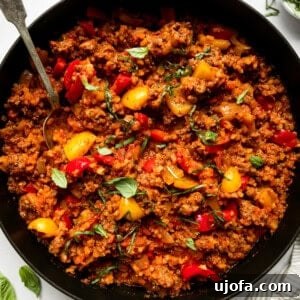 Open-Faced Stuffed Pepper Skillet 6 a deconstructed stuffed pepper in a black skillet with peppers and ground beef