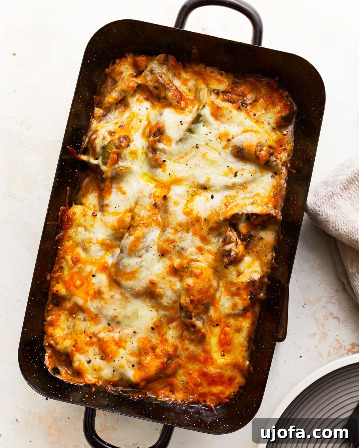 Overhead view of a Philly Cheesesteak Casserole in a casserole dish, fresh from the oven with bubbly cheese.
