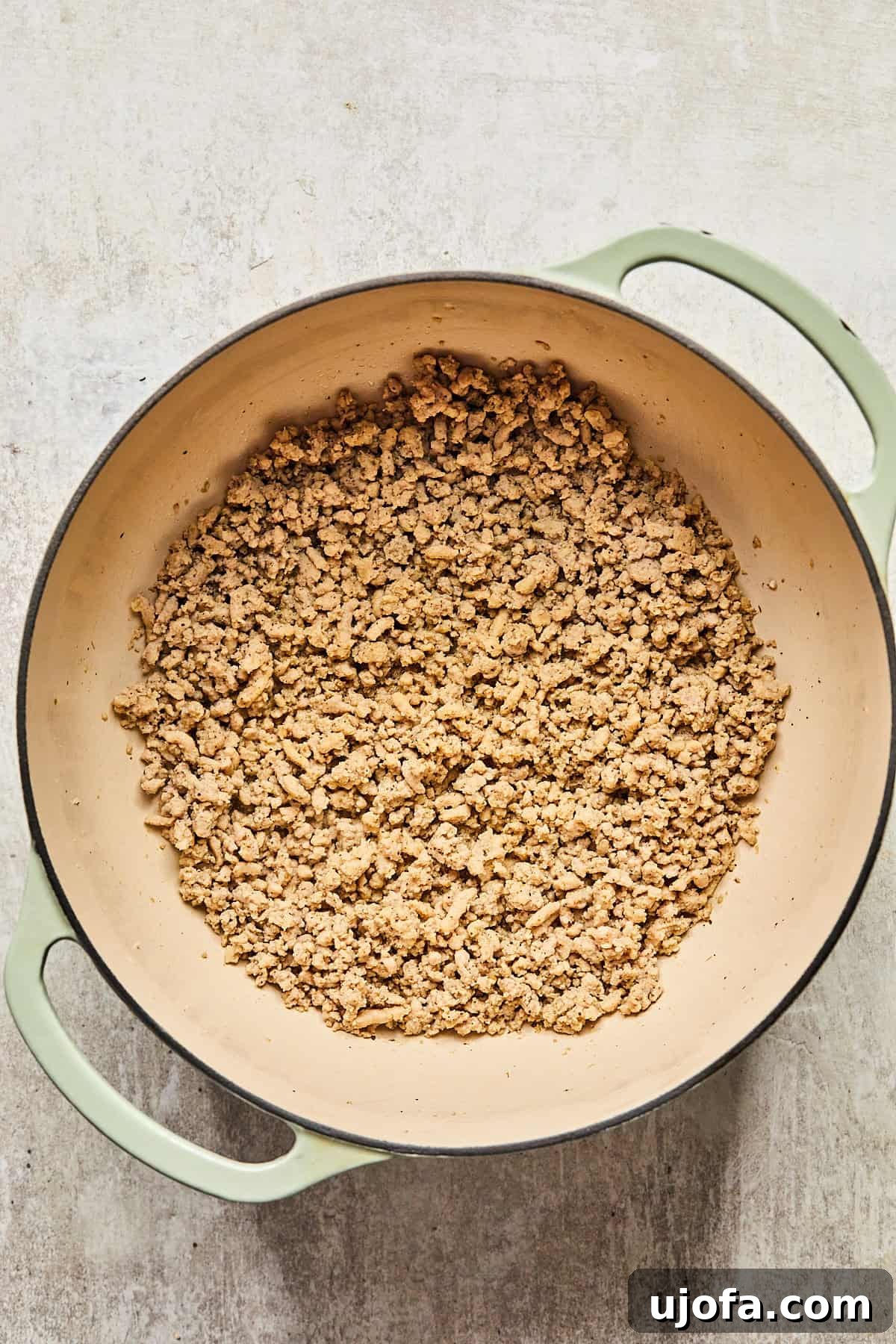 Perfectly cooked and crumbled ground turkey in a pot, ready to be removed and set aside.