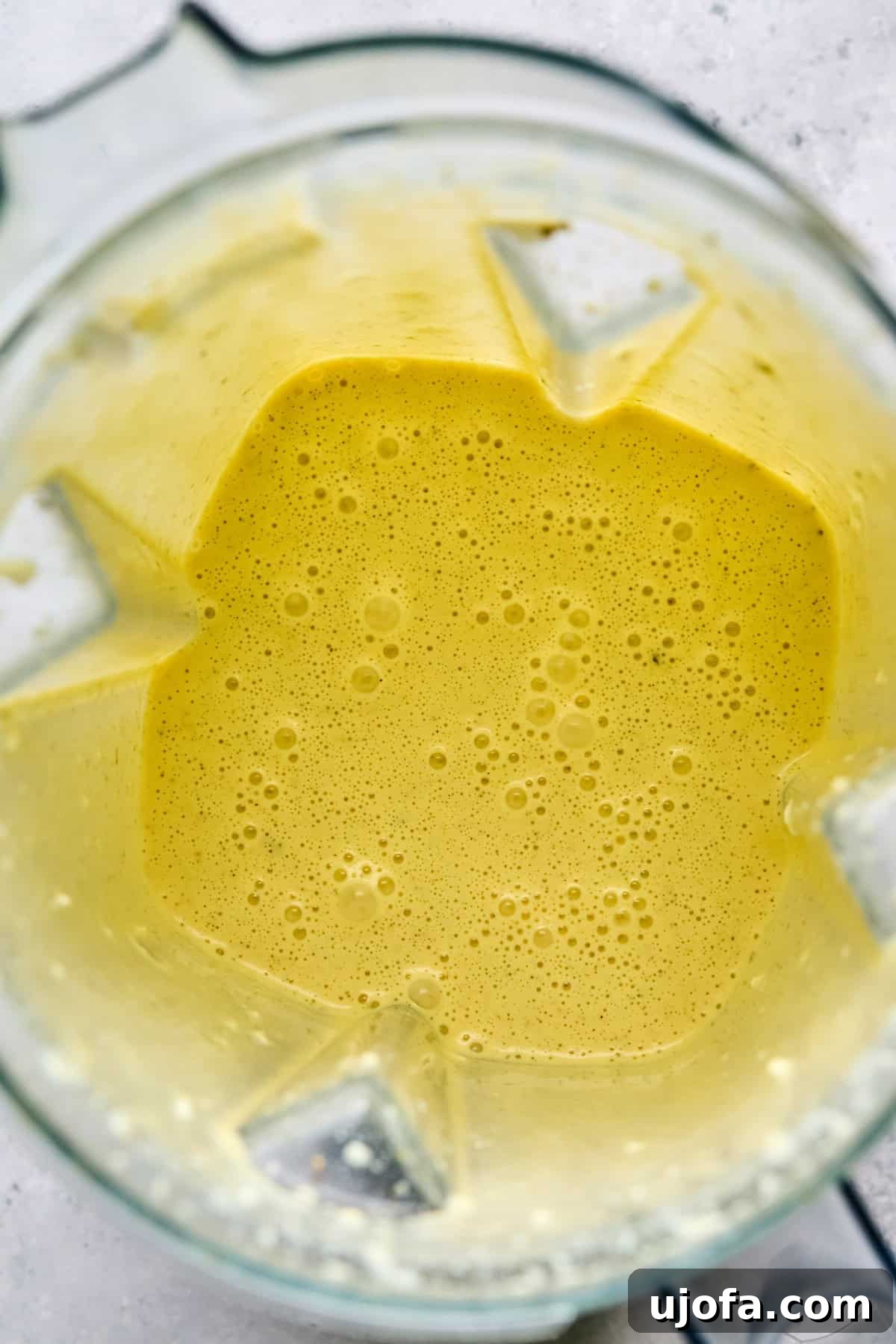 High Protein Cottage Cheese Flatbread Gluten Free Flourless 5 Smooth, blended ingredients for the cottage cheese flatbread in a blender pitcher, ready to be poured.