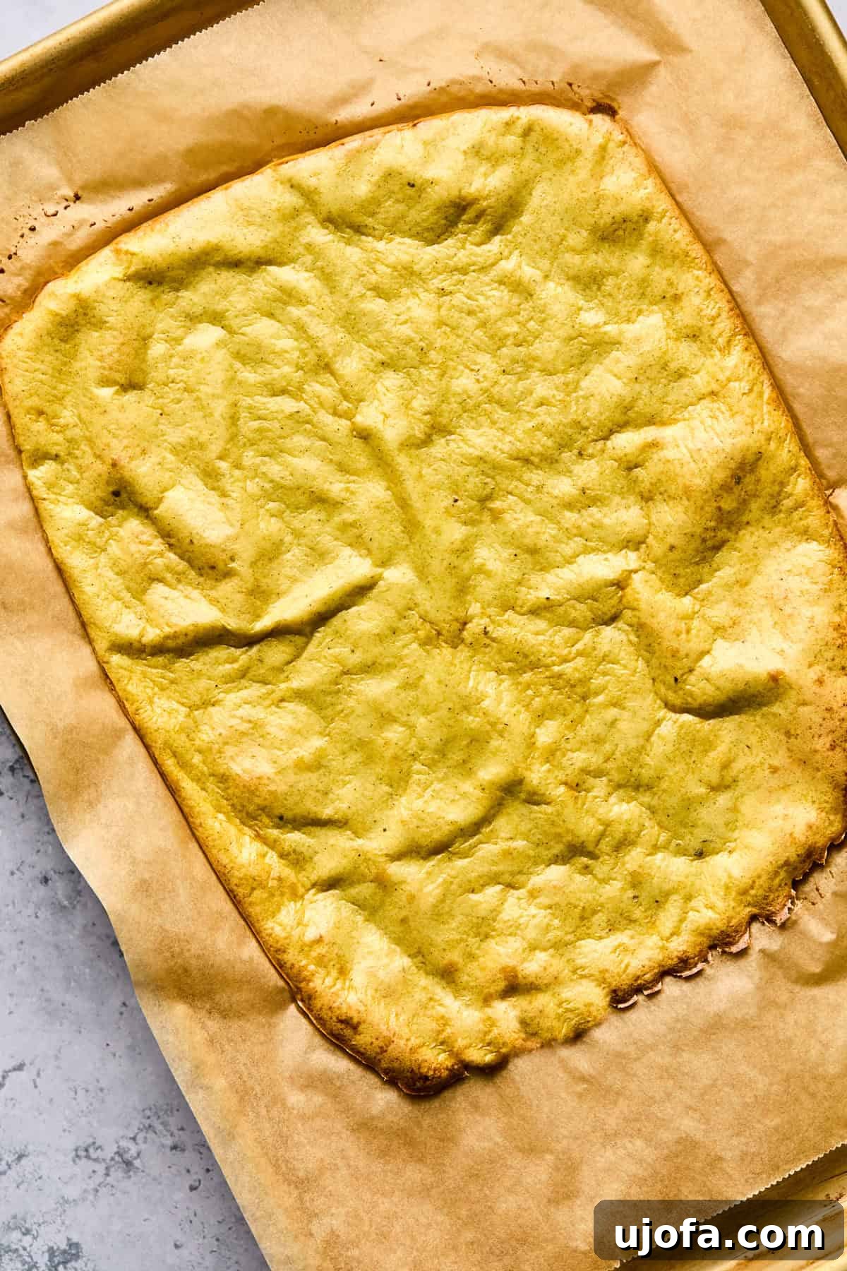 High Protein Cottage Cheese Flatbread Gluten Free Flourless 7 Freshly baked and golden brown cottage cheese flatbread on a baking sheet, ready for cooling and slicing.