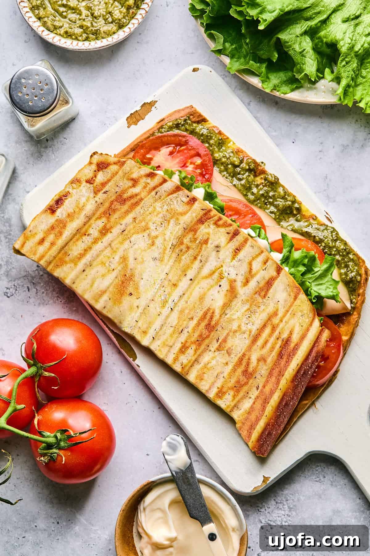 High Protein Cottage Cheese Flatbread Gluten Free Flourless 8 A cottage cheese flatbread generously stuffed with various fillings, presented beautifully on a cutting board.