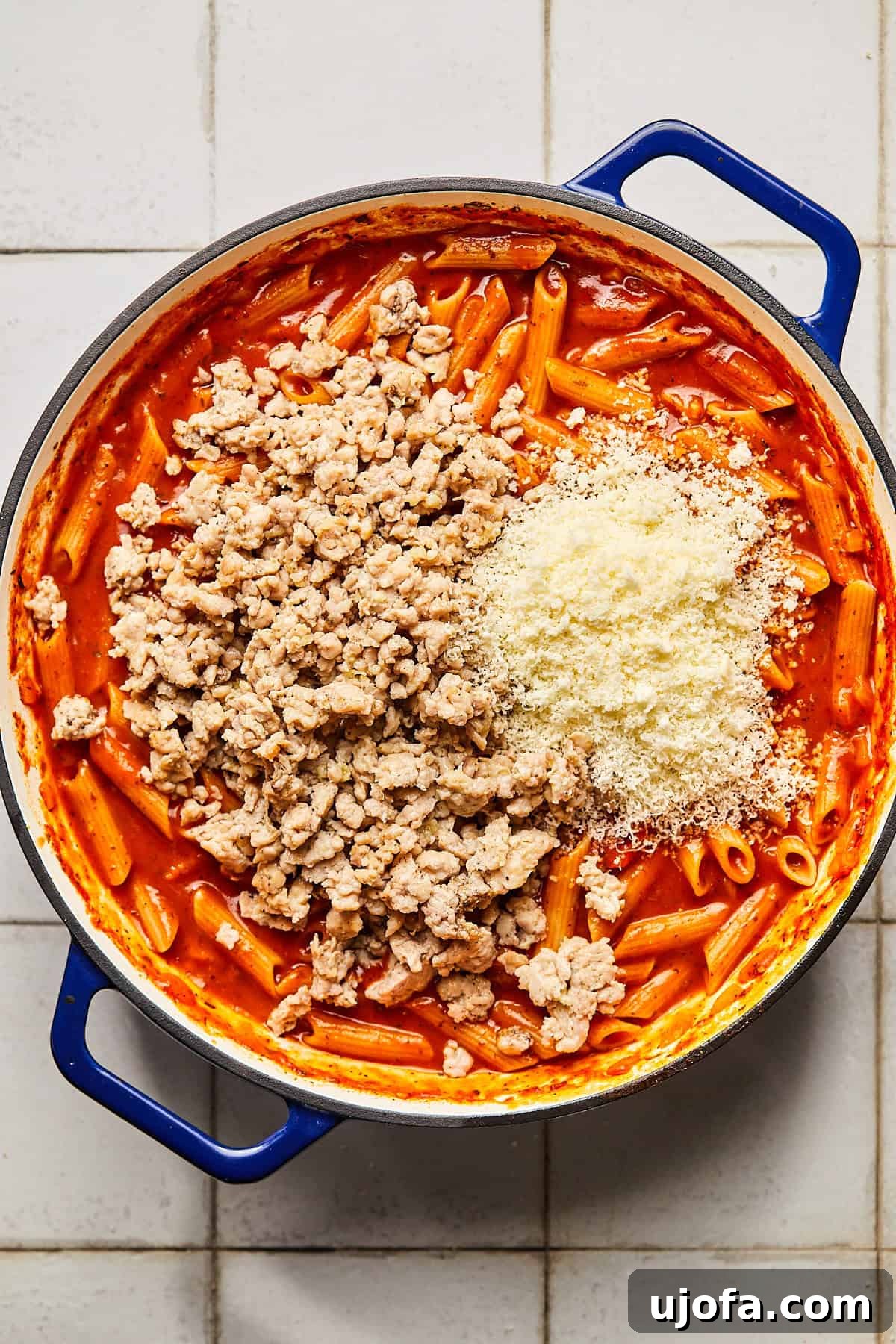 pasta with sauce and ground chicken and parmesan cheese