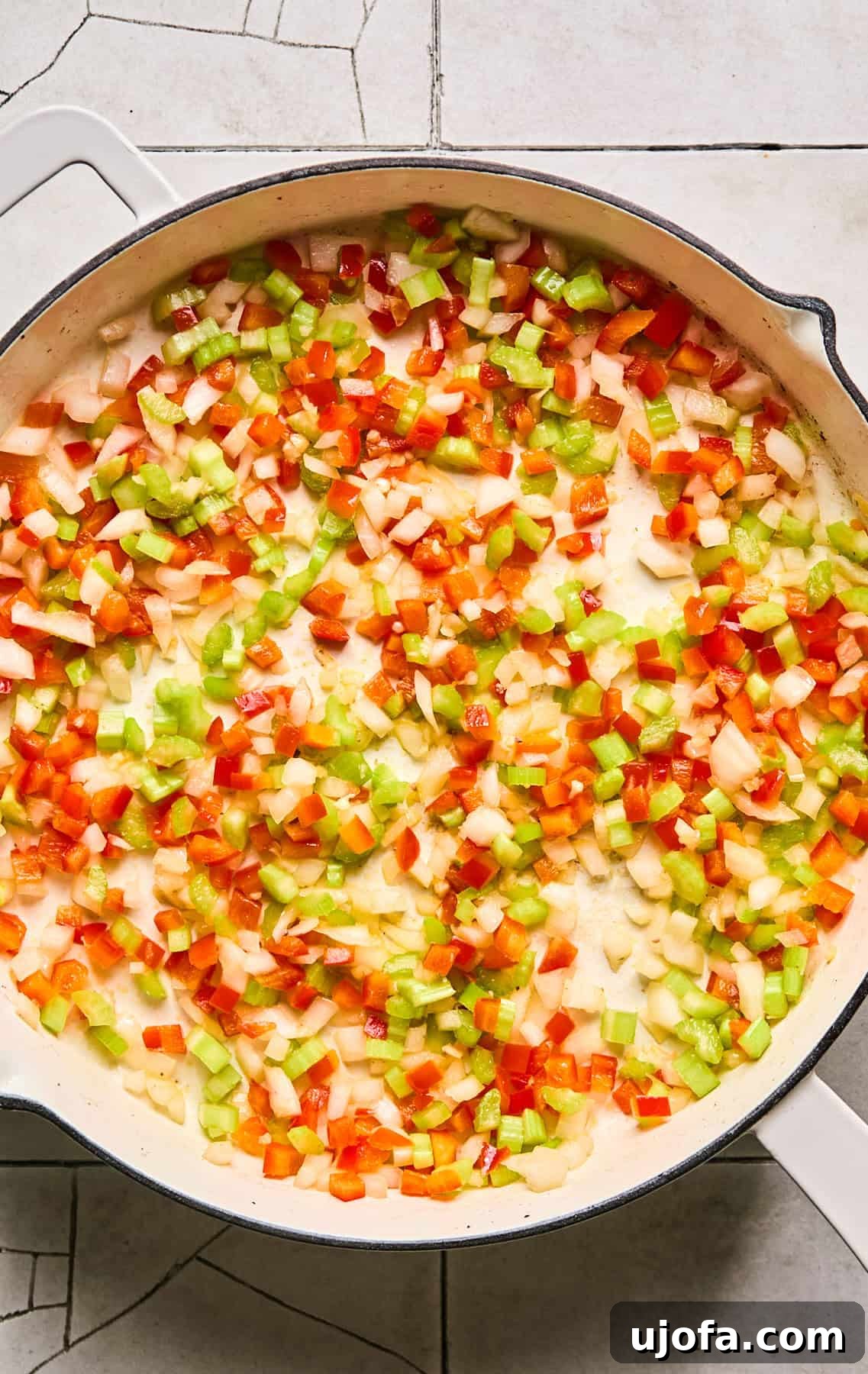 Dirty Quinoa: A Flavorful and Healthy Take on a Classic 5 Onion, celery, green bell pepper, and minced garlic sautéing in a skillet until softened and fragrant.