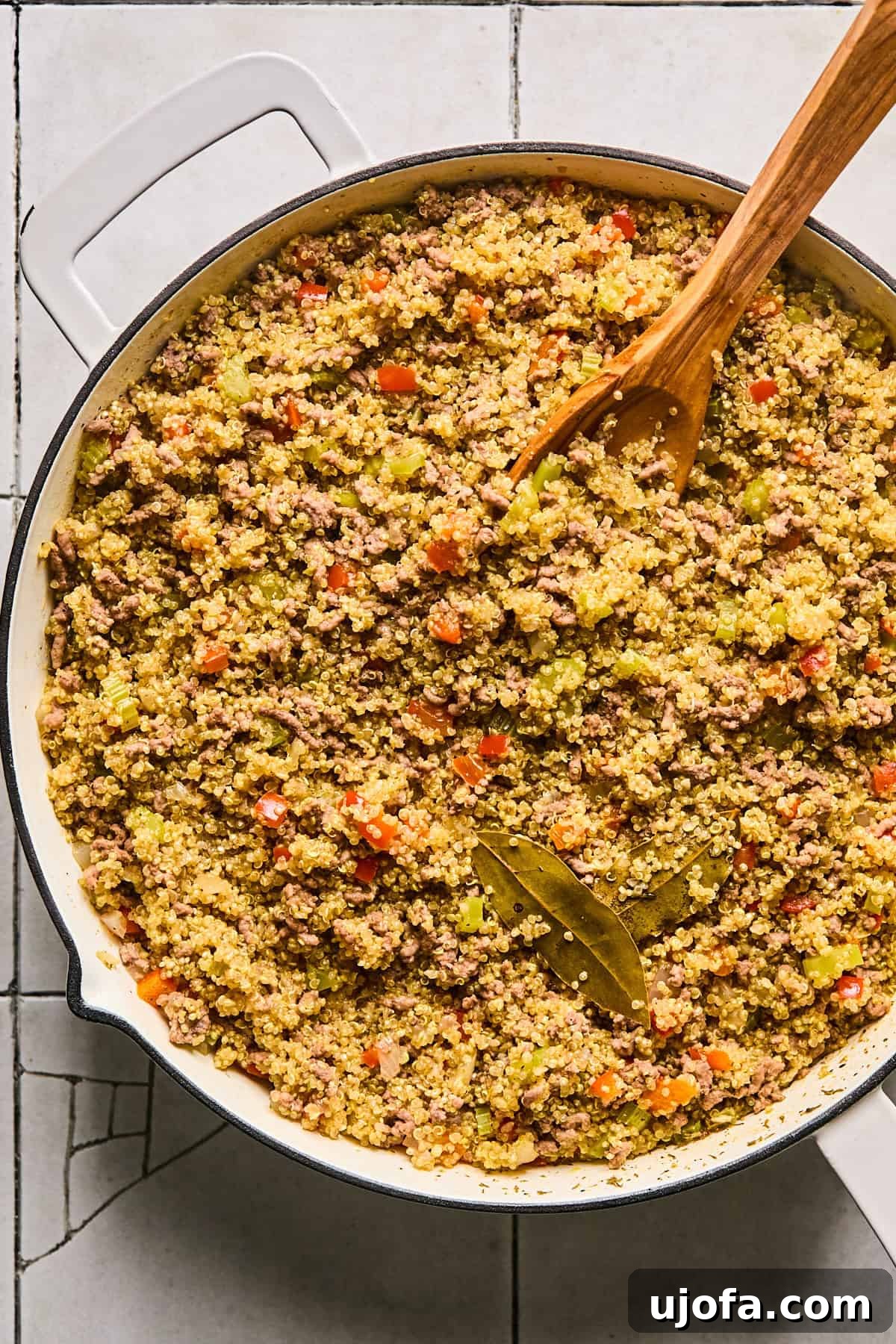 Dirty Quinoa: A Flavorful and Healthy Take on a Classic 8 Bay leaves being carefully removed from the fully cooked dirty quinoa dish.