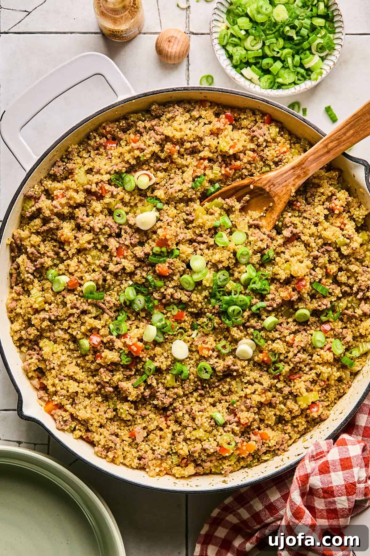 Dirty Quinoa: A Flavorful and Healthy Take on a Classic 9 Diced scallions (green onions) being sprinkled over the top of the finished dirty quinoa, adding freshness and color.