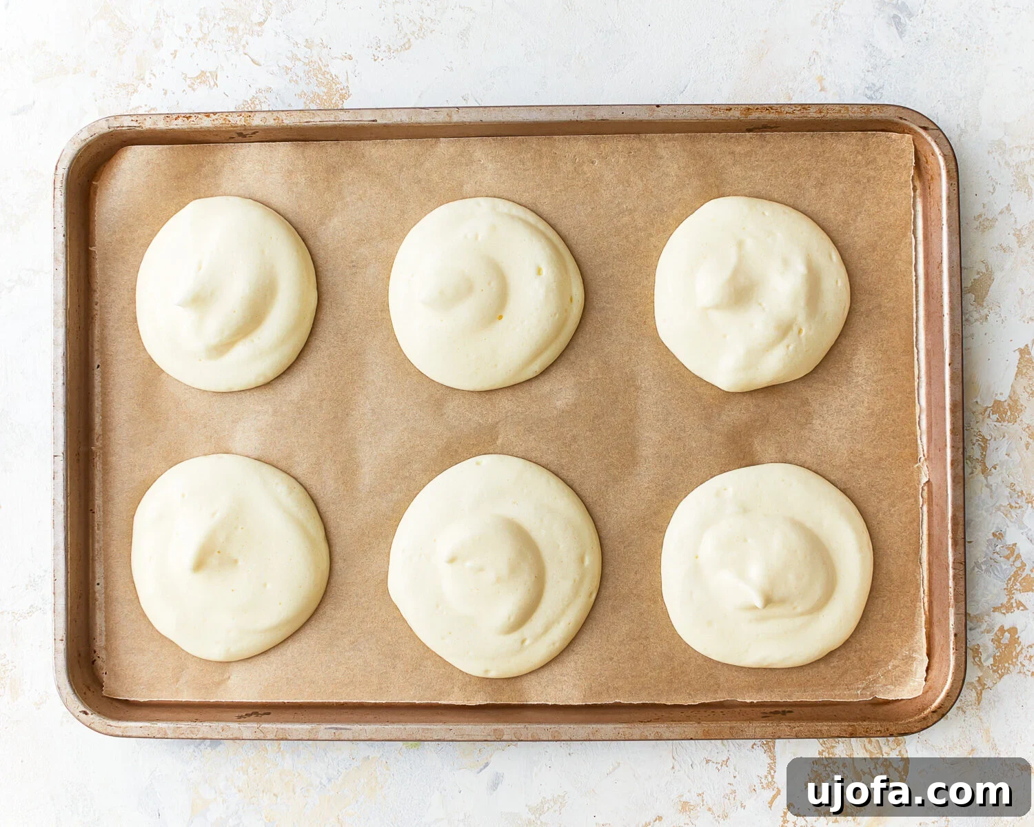 Fluffy Cloud Bread 7 Six rounds of cloud bread batter on a parchment lined baking sheet.