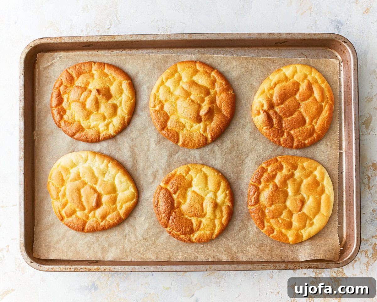 Fluffy Cloud Bread 8 Six slices of freshly baked cloud bread on a parchment lined baking sheet.