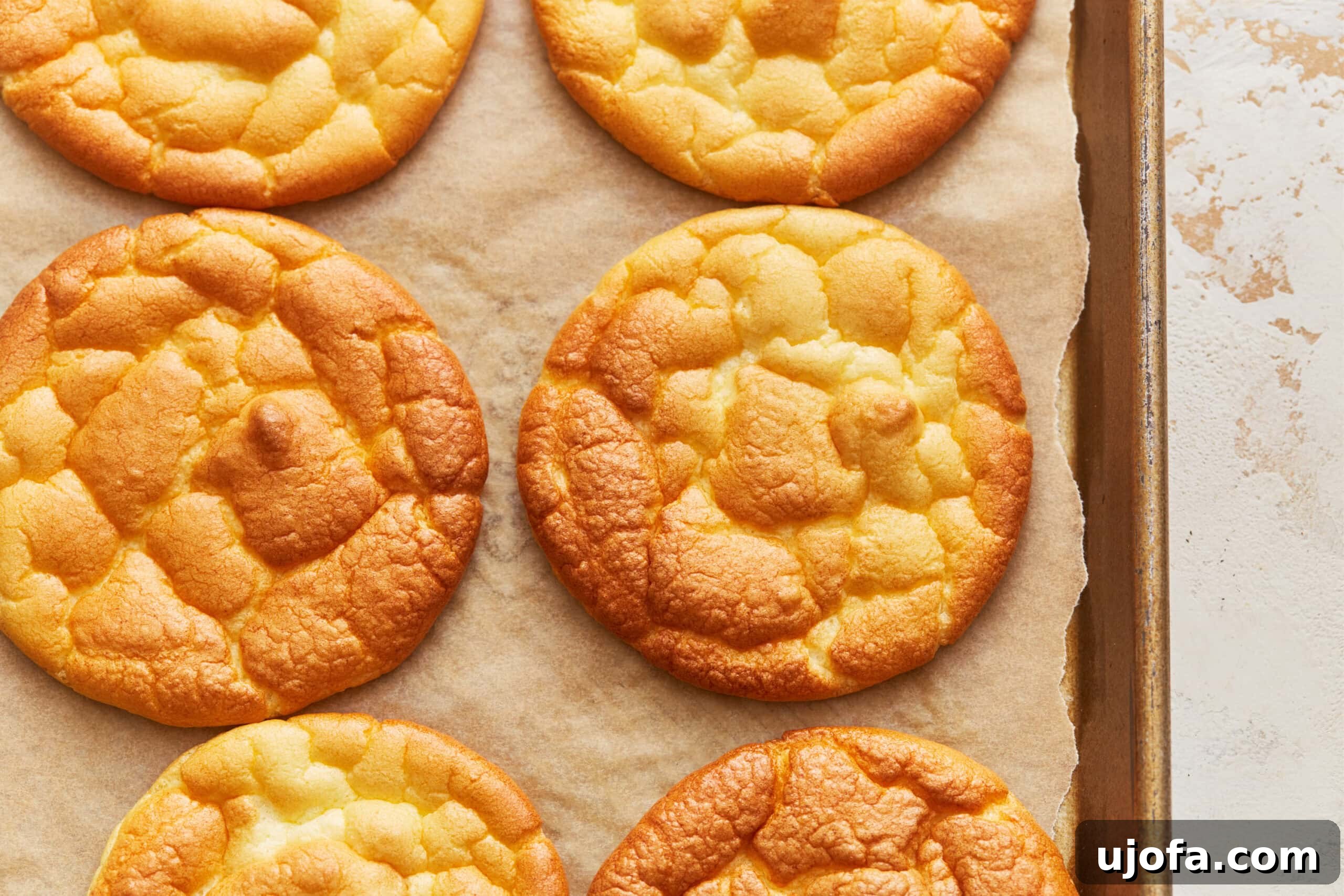 Fluffy Cloud Bread 9 Overhead view of cloud bread rounds on a parchment lined baking sheet.