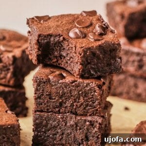 protein brownies stacked up on parchment paper