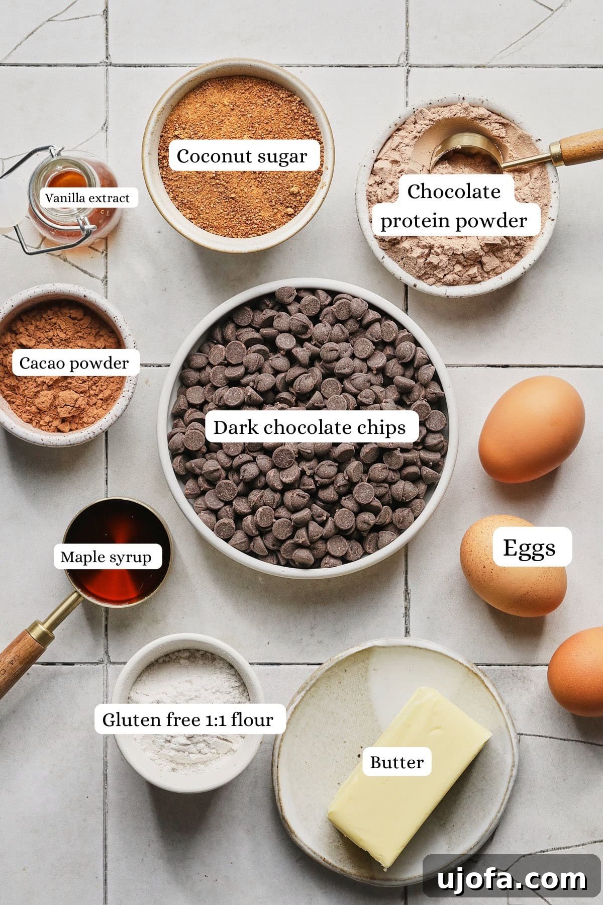 Ingredients for homemade gluten-free protein brownies, including protein powder, cacoa, and eggs.
