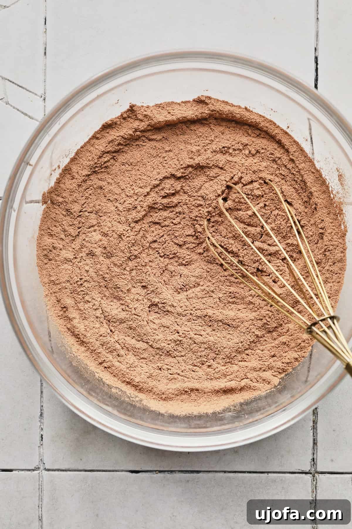 Adding gluten-free flour and protein powder to brownie batter.