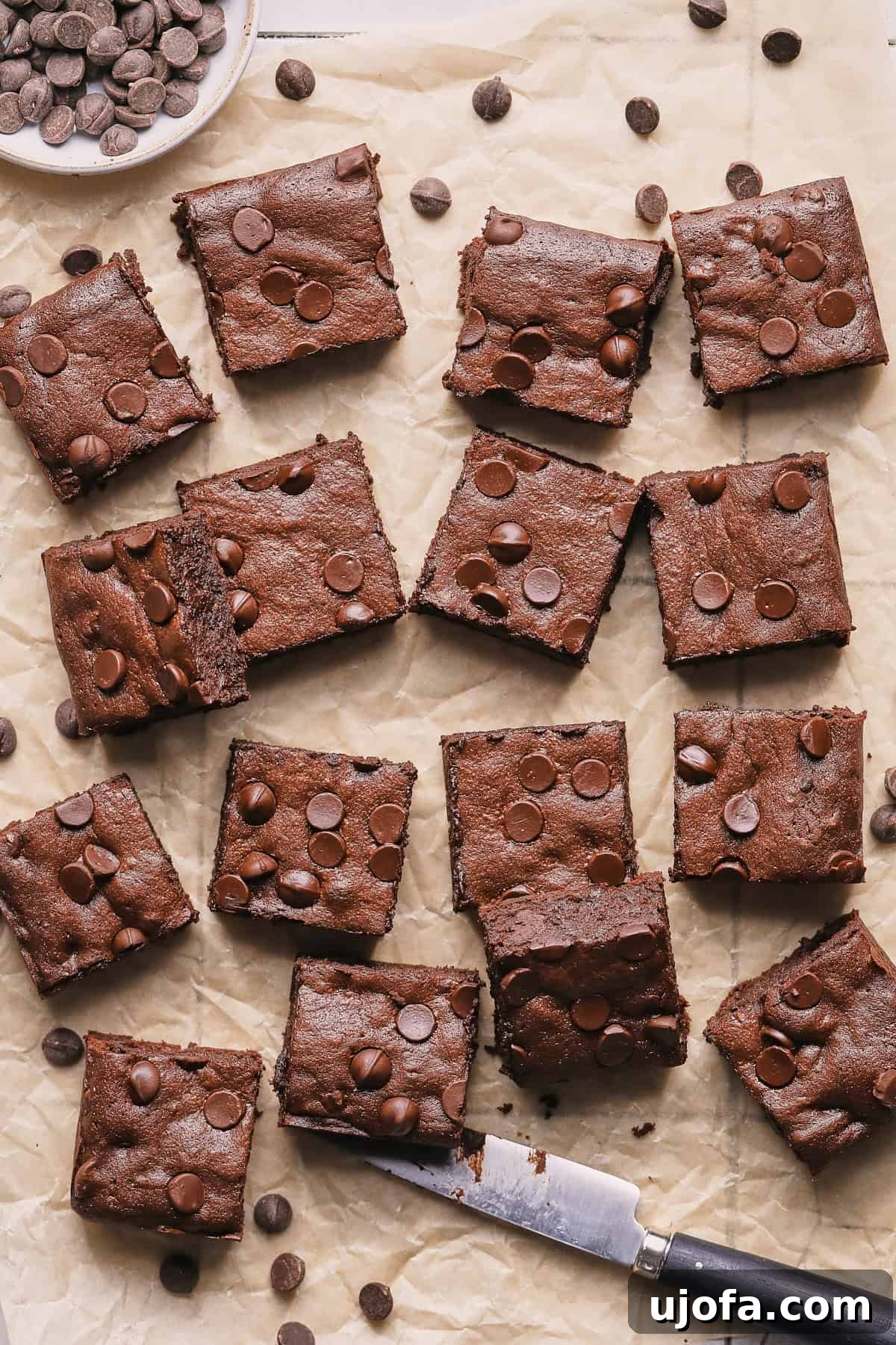 Freshly baked fudgy protein brownies cooled and cut on parchment paper. 