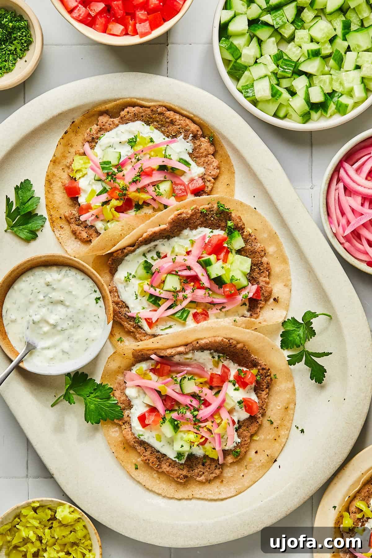 Turkey Gyro Smash Tacos 13 A platter of Greek turkey tacos garnished with fresh herbs and lemon wedges