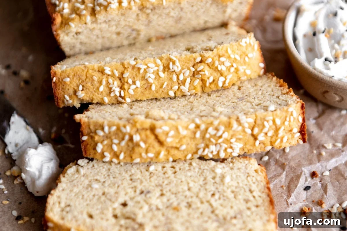 Close-up of neatly cut slices of golden coconut flour bread arranged on a wooden cutting board, highlighting its uniform texture.