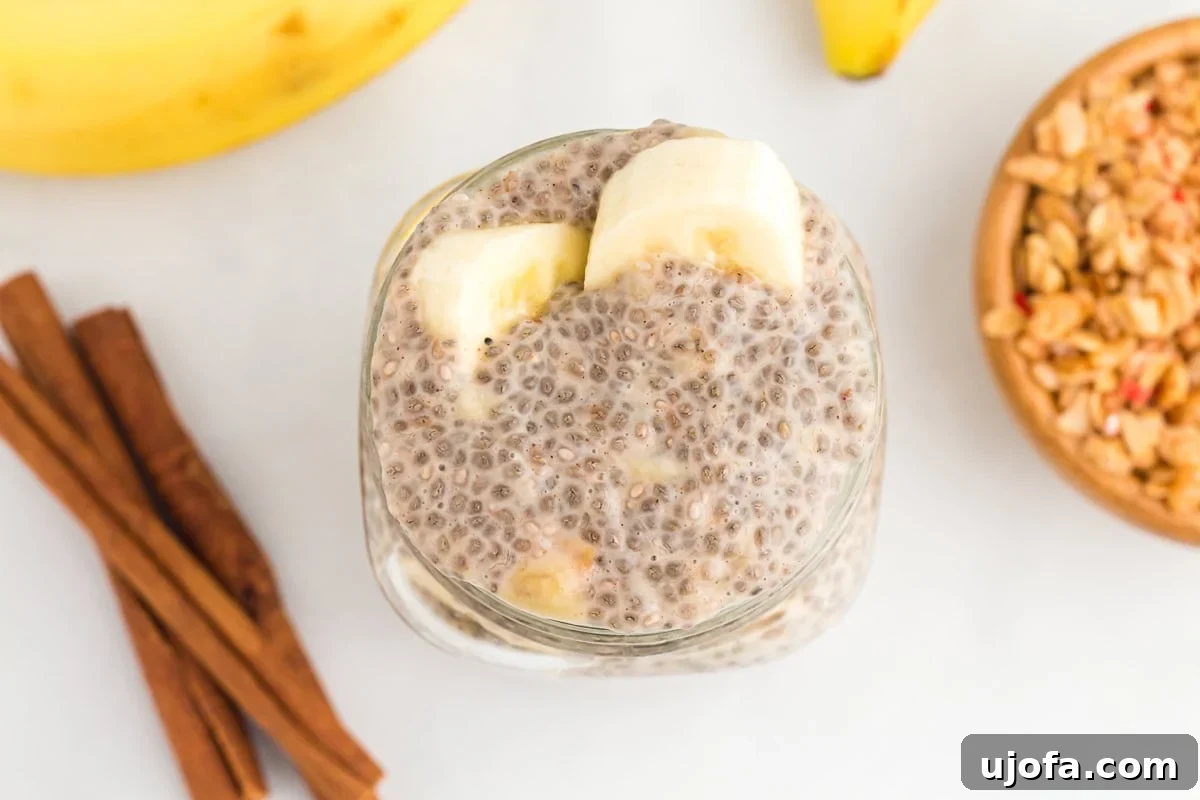 Two clear jars filled with banana chia pudding, with the tops showing the creamy texture and small chia seeds embedded.