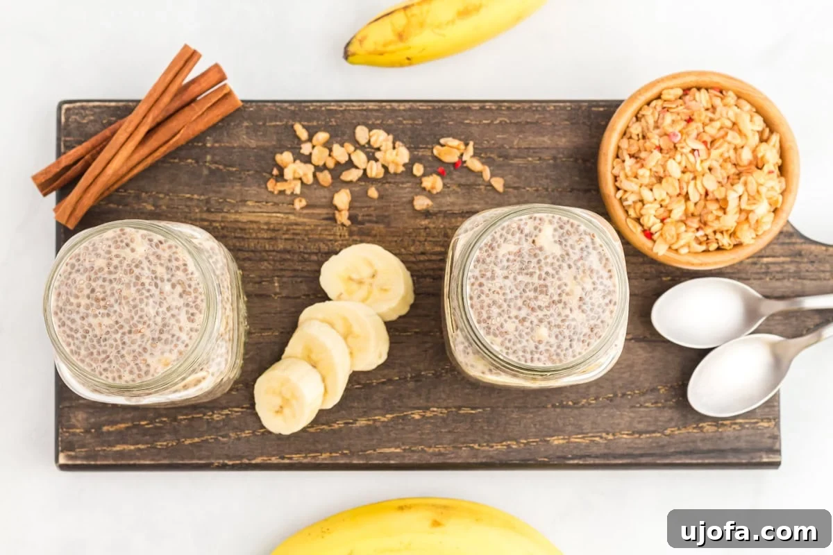 An overhead view showing two individual servings of banana chia pudding in mason jars, ready for serving.