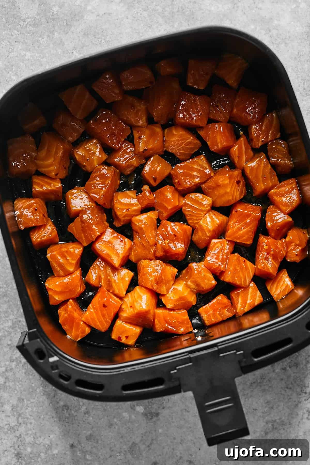 raw salmon cubes in an air fryer