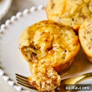 McGriddle Muffins on a plate with syrup and a fork taking a bite out