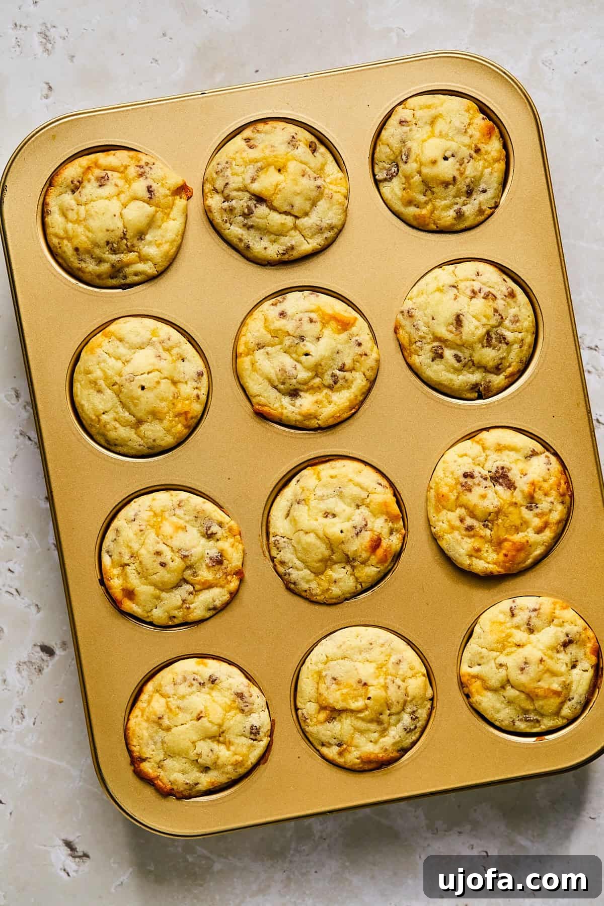 Baked McGriddle muffins with golden tops cooling in the pan