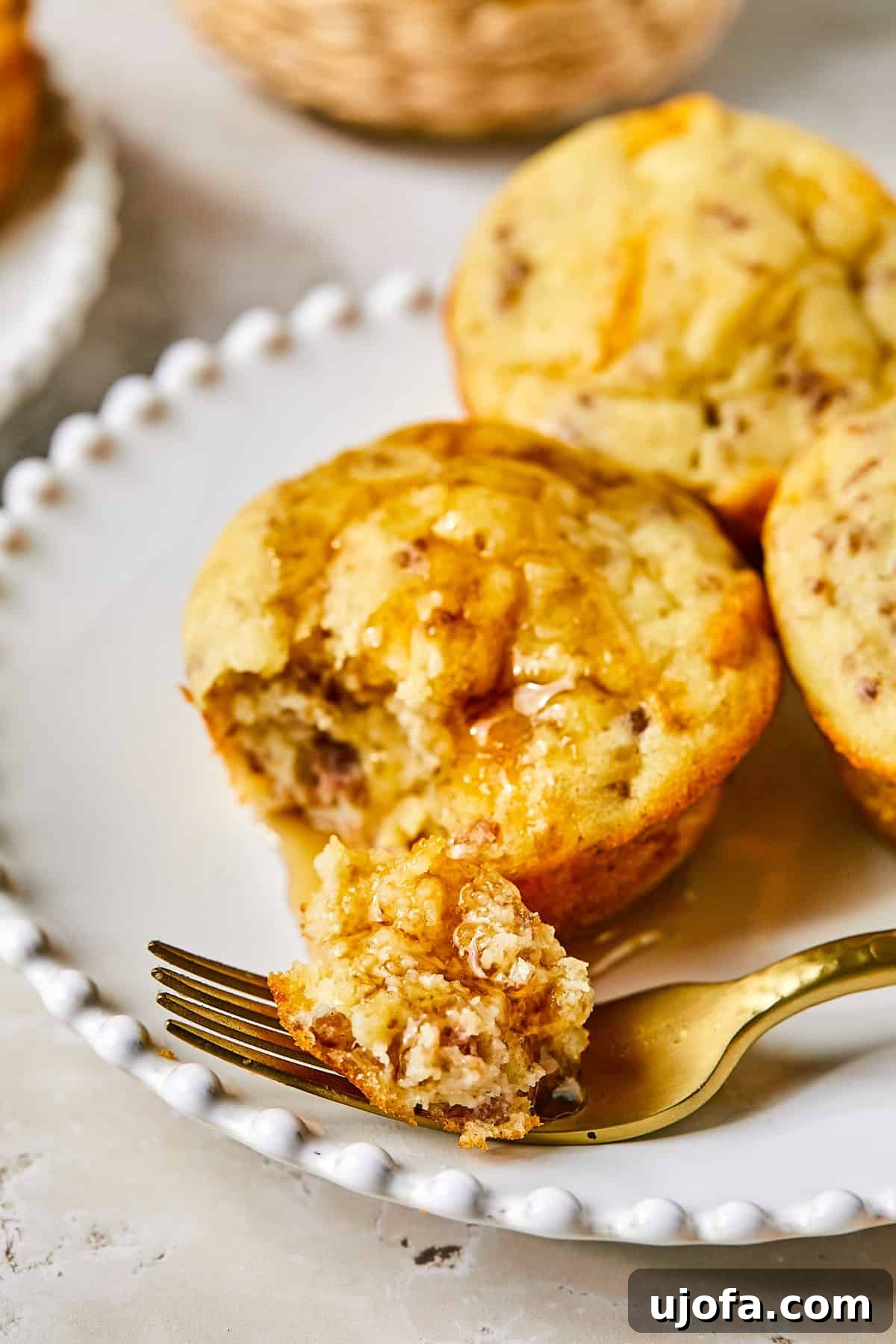 Overhead view of golden McGriddle muffins in muffin tin with maple syrup drizzle