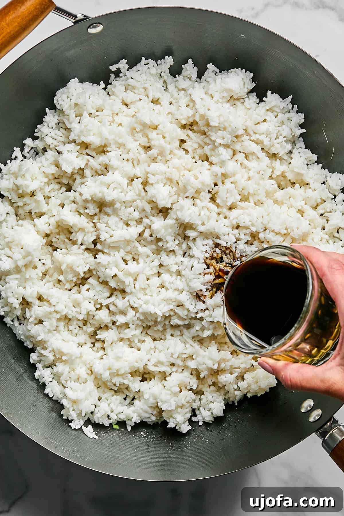 Day-old rice added to the pan and stir-fried with coconut aminos